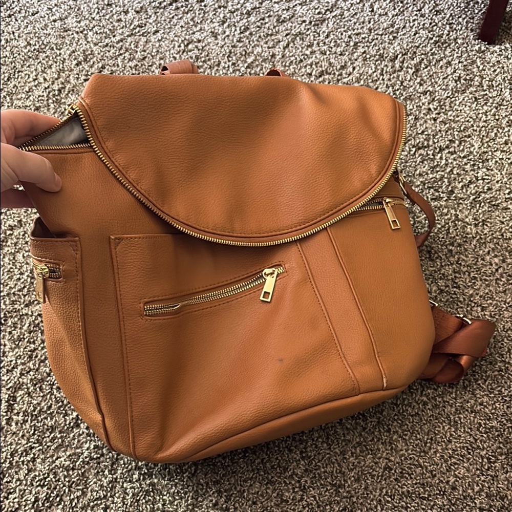 Stylish Orange Backpack with Gold Accents